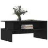 A black coffee table with a vase of flowers and a stack of books on top. Podgląd zdjęcia produktu