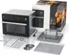 A black and silver air fryer oven with various accessories laid out in front of it, and a product box in the background. Produktbild-Vorschau