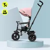 A pink and black children's tricycle is displayed on a light blue and white background, presented on a light blue pedestal. Produktbild-Vorschau