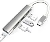 A silver USB C hub with multiple USB ports and card reader slots, along with a 256GB USB drive and two USB flash drives, is displayed on a white background. Produktbild-Vorschau