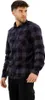 A man wearing a plaid shirt and black pants, posing against a white background. Produktbild-Vorschau