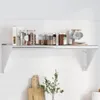 A silver stainless steel wall shelf mounted on a white tiled wall, displaying various kitchen items like jars, a box, and mugs. Produktbild-Vorschau