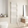 A modern bathroom with a toilet, sink, and a white electric towel warmer. Podgląd zdjęcia produktu