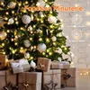 A decorated Christmas tree with gifts underneath, illuminated by string lights. Anteprima dell’immagine prodotto