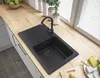 A modern kitchen sink with a black granite basin and a black faucet, set against a light wood countertop. Náhľad obrázku produktu