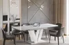 A modern dining room with a white high-gloss extendable dining table and dark gray chairs. Produktbild-Vorschau