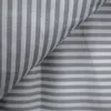 A close-up view of striped fabric, likely bedding, with a fold creating a diagonal line. Produktbild-Vorschau