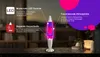 A lava lamp is displayed on a table with decorative elements in the background. Náhľad obrázku produktu