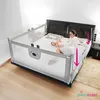 A mother and baby on a bed with a safety rail. Produktbild-Vorschau