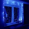 A window decorated with blue LED string lights, creating a festive atmosphere. Náhled obrázku produktu