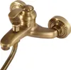 A close-up studio shot of a vintage-style shower faucet with a handheld showerhead attachment. Náhled obrázku produktu