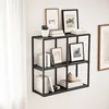 A black metal wall shelf unit filled with books, framed pictures, and a small plant, displayed in a room with white curtains. Anteprima dell’immagine prodotto