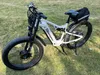 An electric bicycle is parked on a grassy area. Produktbild-Vorschau