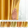 A hand is shown touching a mustard yellow curtain, with a series of smaller images below demonstrating how the color perception changes under different lighting conditions. Produktbild-Vorschau