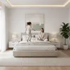 A mother and daughter are playing on a bed in a bedroom. Produktbild-Vorschau