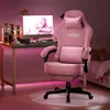 A pink gaming chair is set up next to a desk with a computer and accessories, in a room with pink ambient lighting. Podgląd zdjęcia produktu