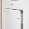 A close-up view of a white bathroom cabinet with one door ajar, revealing a roll of toilet paper inside. Produktbild-Vorschau