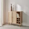 A wooden cabinet with rattan doors and a wine rack section, decorated with two vases and books. Anteprima dell’immagine prodotto
