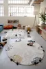 A playroom or children's room with rugs and toys. Voir les images du produit
