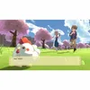 A video game scene with characters and a chicken in a field with cherry blossom trees. Voir les images du produit