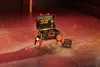 A tool set is displayed on a concrete floor with red lighting. Produktbild-Vorschau
