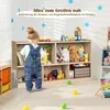 A young child is playing with toys in a room with a wooden toy shelf. There are toys on the shelf and on the floor. Podgląd zdjęcia produktu