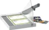A white paper guillotine with two recipe cards on its cutting bed and a recipe book next to it. Náhľad obrázku produktu