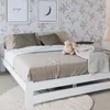 A bedroom scene with a bed, pillows, and decorative items. Produktbild-Vorschau