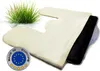 A cream-colored cushion with a black insert, placed on a white surface with a tuft of grass in the background. A circular 'Made in Europe' badge is visible in the lower left corner. Produktbild-Vorschau