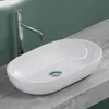 A white vessel sink with a chrome faucet is shown on a gray countertop against a green wall. Produktbild-Vorschau