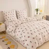 A neatly made bed with floral patterned bedding. Produktbild-Vorschau