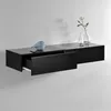 A black floating shelf with one drawer partially open, displayed against a light gray wall. Decorative items, including a blue bird figurine and two glass vases with a single flower, are placed on top of the shelf. Voir les images du produit
