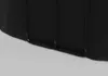 A close-up view of the bottom section of a black product, showing black piping or support structure. Produktbild-Vorschau