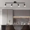 A modern kitchen island with a track light fixture above. Produktbild-Vorschau