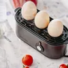An egg cooker with three eggs on top, next to some cherry tomatoes. Anteprima dell’immagine prodotto