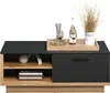 A modern coffee table with a dark top and wooden base, decorated with a decanter, wine glasses, a bottle, and dried grass in a vase. Voir les images du produit