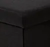 A close-up view of the corner of a black fabric cube or ottoman. Náhled obrázku produktu