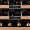 A close-up view of a wine cooler with bottles labeled 'Merlot'. Produktbild-Vorschau