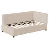 A beige upholstered daybed with a slatted base, shown from a side-angle perspective against a white background. Anteprima dell’immagine prodotto