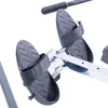 A close-up view of the foot pedals and part of the frame of a rowing machine. Produktbild-Vorschau