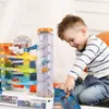 A young boy is playing with a toy parking garage. Podgląd zdjęcia produktu