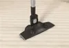 A vacuum cleaner attachment on a carpet. Voir les images du produit