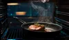 A steak is being cooked in a pan inside an oven. Náhľad obrázku produktu