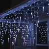 Icicle lights are hung on the eaves of a house, illuminating the exterior at night. Produktbild-Vorschau