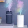 Two aroma diffusers emitting colorful mist, placed on shelves with books. Produktbild-Vorschau