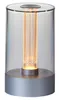 A close-up studio shot of a silver and clear LED table lamp with an exposed filament bulb. Produktbild-Vorschau