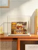 A miniature bakery display case inside a clear acrylic box, placed on a wooden shelf. Podgląd zdjęcia produktu