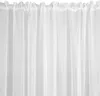 A close-up view of white sheer curtains with a gathered heading. Produktbild-Vorschau