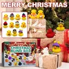 A collection of Christmas-themed rubber ducks and gift-wrapped presents arranged around a Christmas tree. Produktbild-Vorschau