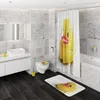 A modern bathroom with marble-tiled walls, a white vanity with a sink, a toilet with a matching seat cover, a bathtub, and a shower curtain featuring a large rubber duck print. The floor is dark wood. Náhled obrázku produktu